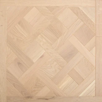 Light oak parquet with herringbone blocks and framed border details creates a warm, natural wood surface in a pale, refined finish.